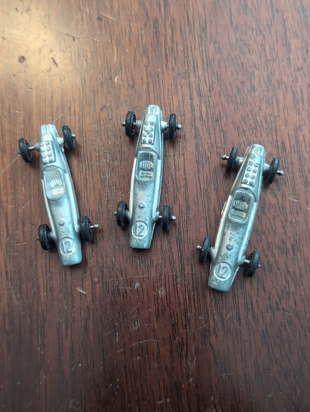 Lot 3 vintage Tootsie Toy Indy #12 racecar toys in silver, measuring 2.25 inches